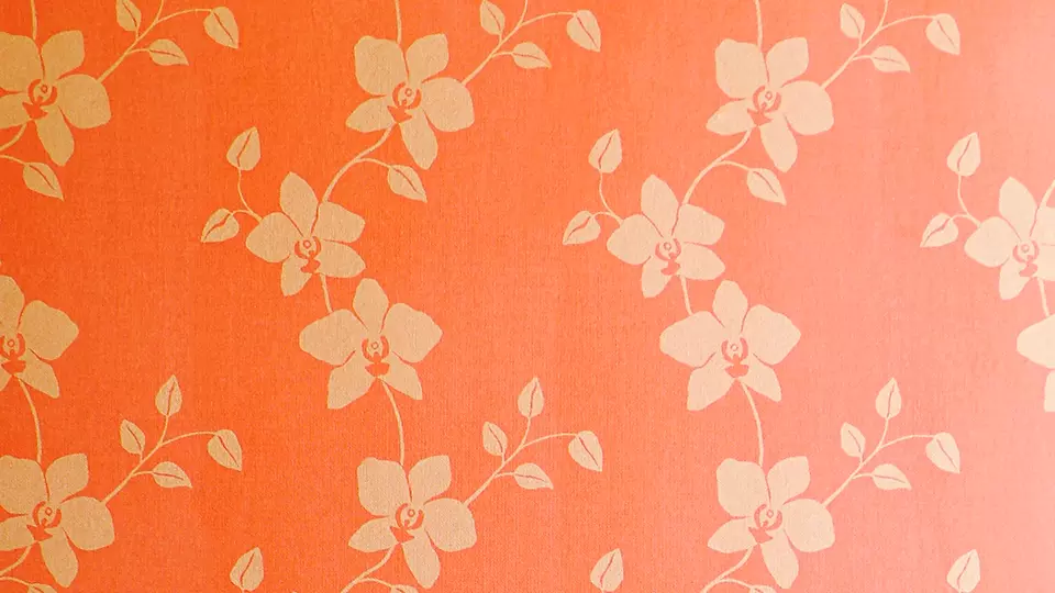 Applying filler to a wallpapered wall